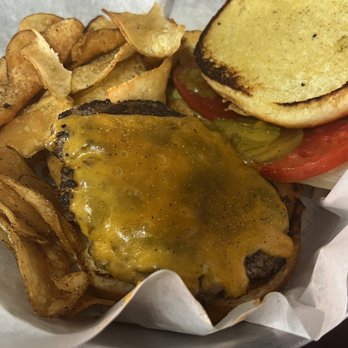 The 377 Brewery - Amazing Burger - A cheeseburger with melted cheddar cheese, accompanied by potato chips, pickles, tomato slices, and a toasted bun. - Brewpubs Near Me - Albuquerque, New Mexico
