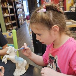 Granddaughter painting a unicorn.