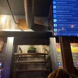 Pour Bros Taproom - Beer board in front of the self-pour wall