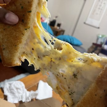 Twisted Grilled Cheese - a hand holding a piece of bread - Food Trucks Near Me - Houston , Texas Twisted Grilled Cheese - a hand holding a piece of bread - Food Trucks Near Me - Houston , Texas
