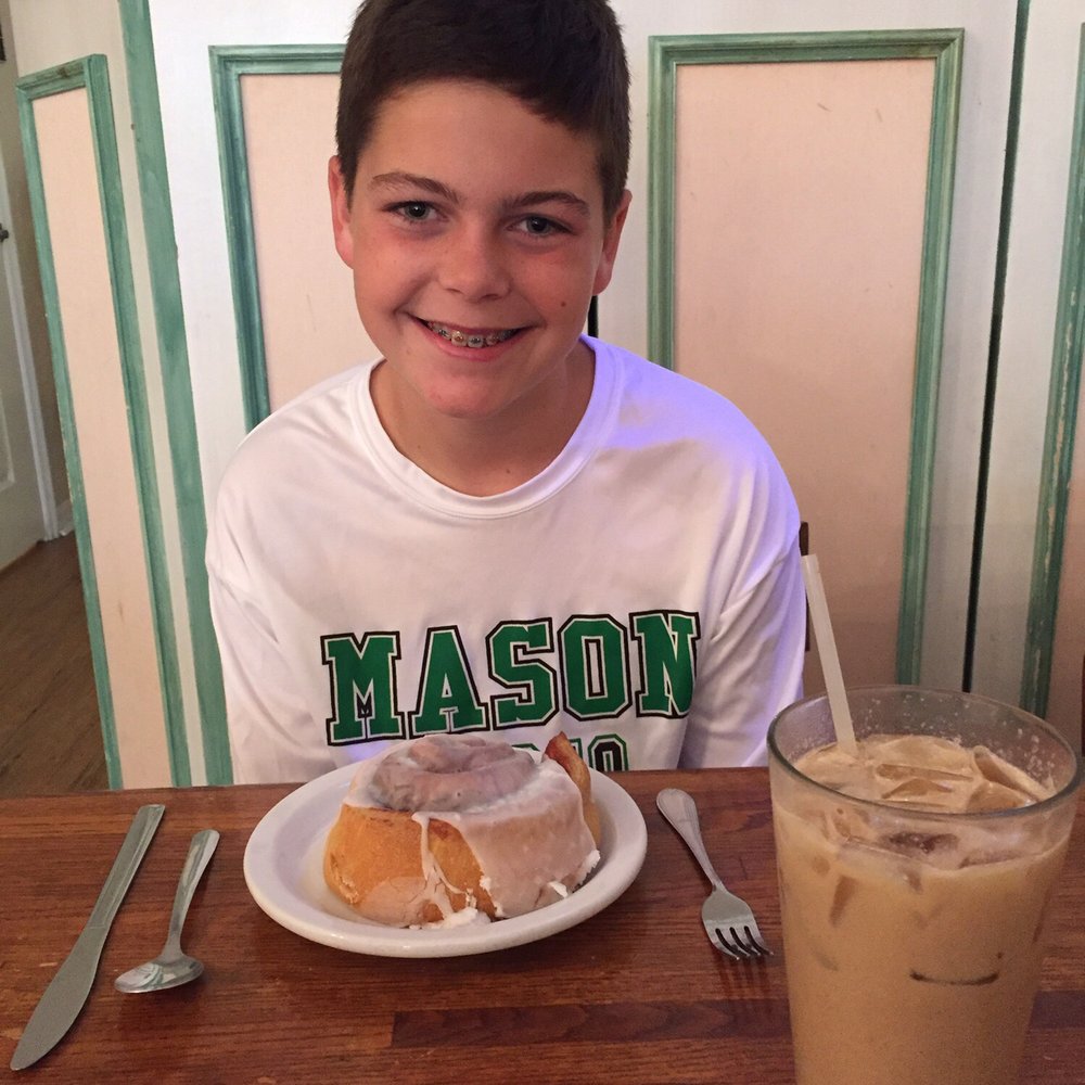 Upper Crust Cafe & Bakery - Cinnamon roll, iced chai latte, and a cutie! - American Near Me - Venice, Florida