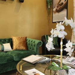 Our inviting lobby blends elegance and comfort with plush seating, fresh orchids, and a curated selection of beaty magazines.