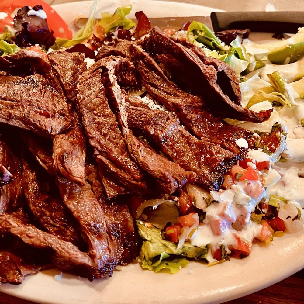 Carne Asada Salad with slices tomatoes and avocados on a bed of lettuce with ranch dressing. Carne Asada Salad with slices tomatoes and avocados on a bed of lettuce with ranch dressing.