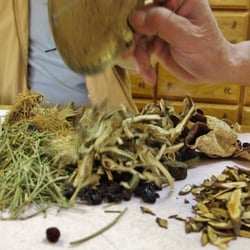 Shop assistant assembling together my prescription of Chinese herbs.