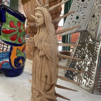 Casa Talavera - A carved wooden sculpture depicts a woman with long hair and a serene expression, with wooden spikes extending from her back. - Home & Garden Near Me - Albuquerque, New Mexico