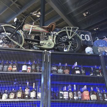 Sweet Caroline’s Kitchen & Cocktails - Motorcycle decor above booze locker - Sports Bars Near Me - Ames, Iowa