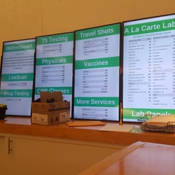 Wellnessmart - There's plywood on the wall and the price list sits on a counter.