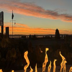 Baywood Inn Bed & Breakfast - Sunset at the fire pit. Wine glass in hand.