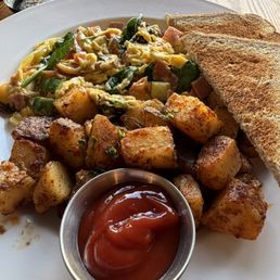 The Scrambled with Ham and Cheddar, potatoes (nicely spiced), wheat toast. The Scrambled with Ham and Cheddar, potatoes (nicely spiced), wheat toast.