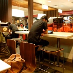McDonald's - Staff watching tablet in uniform in the midst of a filthy restaurant.