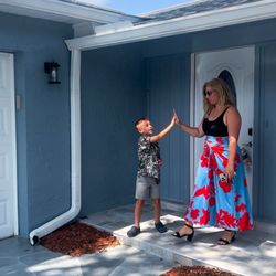 The Caruso Group - Keller Williams Realty - A candid shot of Tracey and our son high-fiving at the last house of the day.