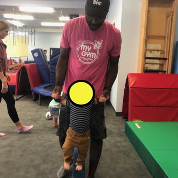 My Gym - Charles with my son on the balance beam. You can't see it, but my son is smiling even though he doesn't like other people touching him. - Kids Activities Near Me - Santa Barbara, California My Gym - Charles with my son on the balance beam. You can't see it, but my son is smiling even though he doesn't like other people touching him. - Kids Activities Near Me - Santa Barbara, California