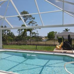 Lester's Aluminum - Modified mansard pool enclosure. Picture window screen patio