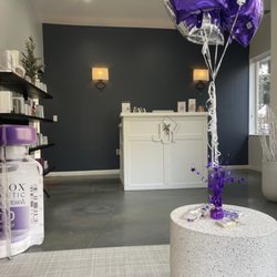 Urenewed - Front desk/ a wall of products they sell. It was Botox day, so they had cute decorations and free cookies!