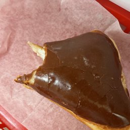 a half eaten donut in a basket