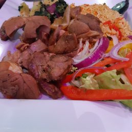 Goat with saffron rice and crisp, clean vegetable salad.