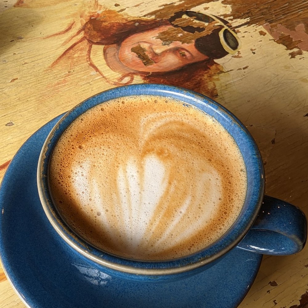 The Only Cafe - Coffee on patinaed table - Coffee & Tea Near Me - Toronto, Ontario