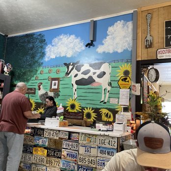 Red Rooster Cafe - License plates and cow mural. Check out counter - New American Near Me - Danville, Kentucky