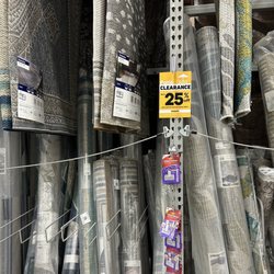 Lowe's Home Improvement - Misleading placement of sign -- no rugs are included in the sale.