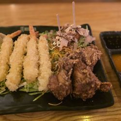 Sakura Teriyaki - Appetizer combo: Egg rolls, dumplings, fried shrimp, chicken wings, takoyaki balls, dipping sauces.
