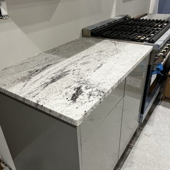 Meta Stone - River White granite has low variations in its white and gray veining with small deep burgundy flecks. 3-15-2024 - Countertop Installation Near Me - Farmingdale, New York Meta Stone - River White granite has low variations in its white and gray veining with small deep burgundy flecks. 3-15-2024 - Countertop Installation Near Me - Farmingdale, New York