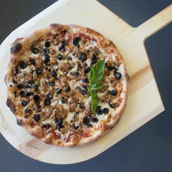 Pizzeria Toppings - a pizza on a wooden board - Pizza Near Me - Laval, Ste Dorothee, Quebec Pizzeria Toppings - a pizza on a wooden board - Pizza Near Me - Laval, Ste Dorothee, Quebec