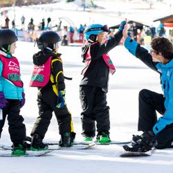 Adventure Academy - Bear Mountain - High fives for snowboard lessons.