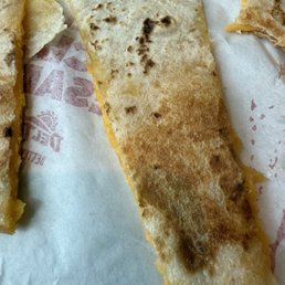 A flower tortilla with a tiny bit of cheese. A sorry food. A flower tortilla with a tiny bit of cheese. A sorry food.