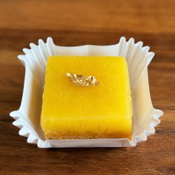 Sweet Crimes - Gluten-free lemon bar with silky olive oil lemon curd on shortbread crust, finished with gold leaf. Seasonal & fresh at Sweet Crimes DC.