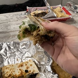 a hand holding a piece of food a hand holding a piece of food