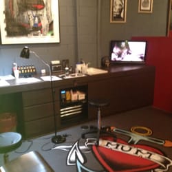 Liquid Silver - Tattoo on Hoddle - Each den is identical with a LCD TV & headphones if you choose to tune out while being inked.