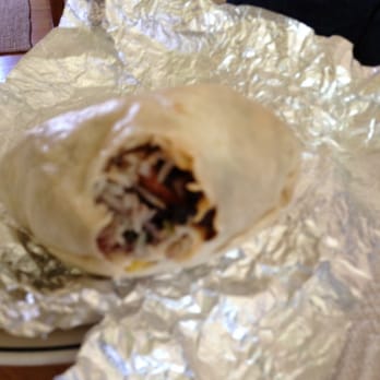 QDOBA Mexican Eats - Chicken Burrito just one bite in. - Mexican Near Me - Fox Point, Wisconsin