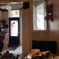 Maddie Hatter Tea Shop & Cafe - Entryway and front of shop, more seating behind and over the half wall to the right