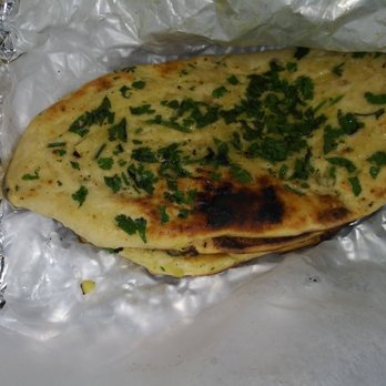 Cali Tardka - Garlic Naan. Fresh baked and delicious when dipped in masala sauce. - Indian Near Me - Riverside, California Cali Tardka - Garlic Naan. Fresh baked and delicious when dipped in masala sauce. - Indian Near Me - Riverside, California