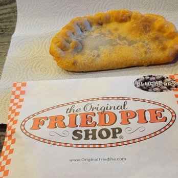 Baker's Ribs - a hand holding a fried pie - Barbeque Near Me - Greenville, Texas Baker's Ribs - a hand holding a fried pie - Barbeque Near Me - Greenville, Texas