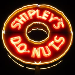 a neon sign for a donut shop