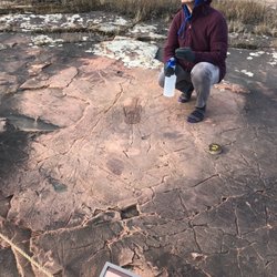 Jeffers Petroglyphs - Staff spaying petroglyphs with water to help reveal them.