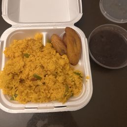Arroz Con Pollo with yellow rice served with black beans and plantains. Arroz Con Pollo with yellow rice served with black beans and plantains.