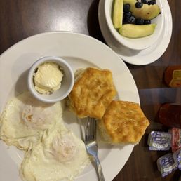 The "Sunrise" breakfast. Over easy eggs, fruit instead of hash browns, and biscuits as my choice of bread.