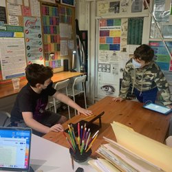KidWritersLA - Two boys discussing their creative writing project.