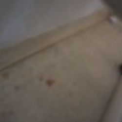 Montebello Care Center - Dirt behind the bed and dirt stains