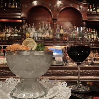 Hy's Steak House - Shrimp cocktail on an iced chalice next to one of the many wine list classy pours. - Steakhouses Near Me - Honolulu, Hawaii