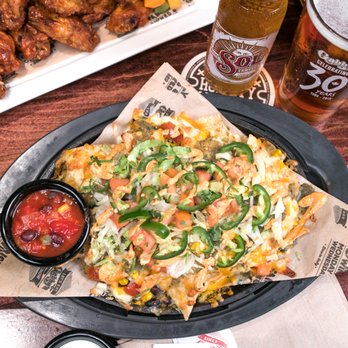 Gabby's Junction - a plate of nachos and wings - Canadian (New) Near Me - Toronto, Ontario Gabby's Junction - a plate of nachos and wings - Canadian (New) Near Me - Toronto, Ontario