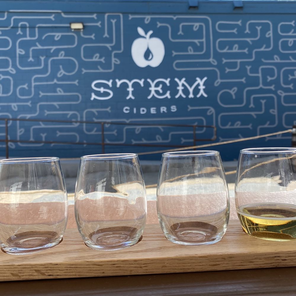 Stem Ciders - Outside the building at a picnic table - Bars Near Me - Denver, Colorado Stem Ciders - Outside the building at a picnic table - Bars Near Me - Denver, Colorado