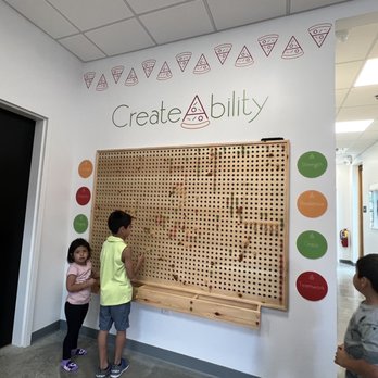 SliceAbility - two children playing a board game - Pizza Near Me - Cumming, Georgia