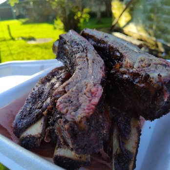 Sinister BBQ - a plate of ribs on a table outdoors - Caterers Near Me