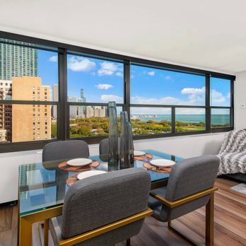 Eleven Thirty - Dining area with glass table and lake views - Apartments Near Me - Chicago, Illinois Eleven Thirty - Dining area with glass table and lake views - Apartments Near Me - Chicago, Illinois