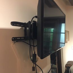 TV Cords hanging all over the wall.