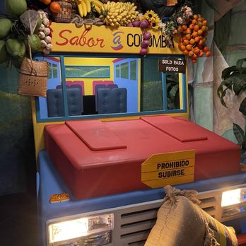 Sabor A Colombia - a fruit stand with a hat on - Steakhouses Near Me - Levittown, New York