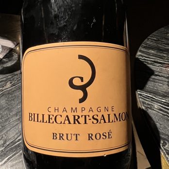 Clement - a bottle of champagne on a table - New American Near Me - New York, New York